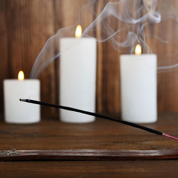 Incense stick burning with candles